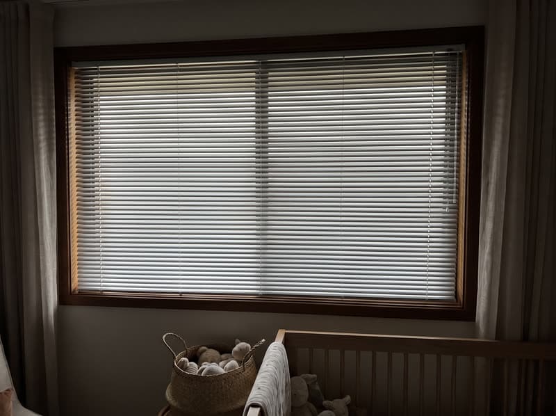 Aluminum blind on a nursery window in a new build in a modern subdivision in Suwanee