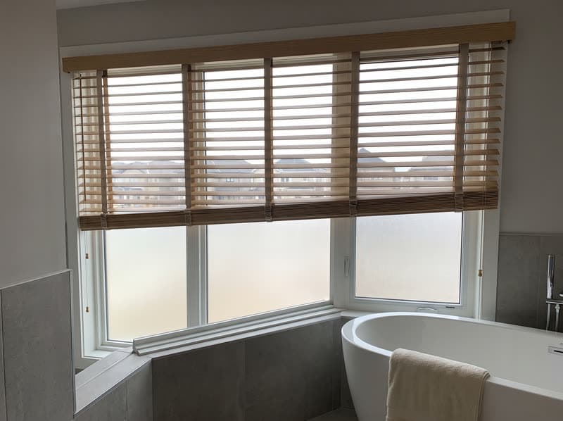 Faux wood blind on a bathroom window in a new build in a modern subdivision in Sandy Springs
