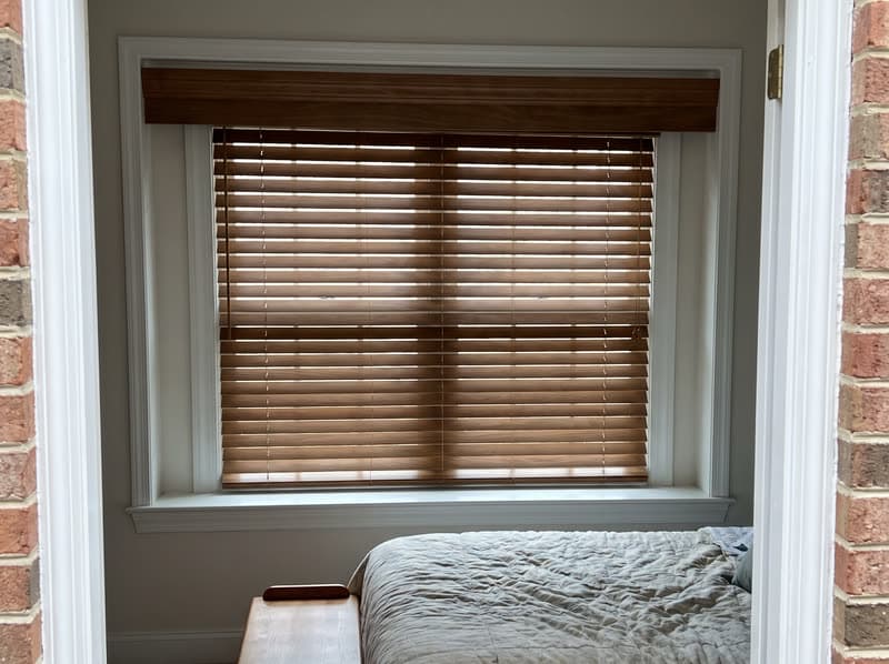 Wood blind on a guest bedroom window in a 1990s brick colonial in Woodstock