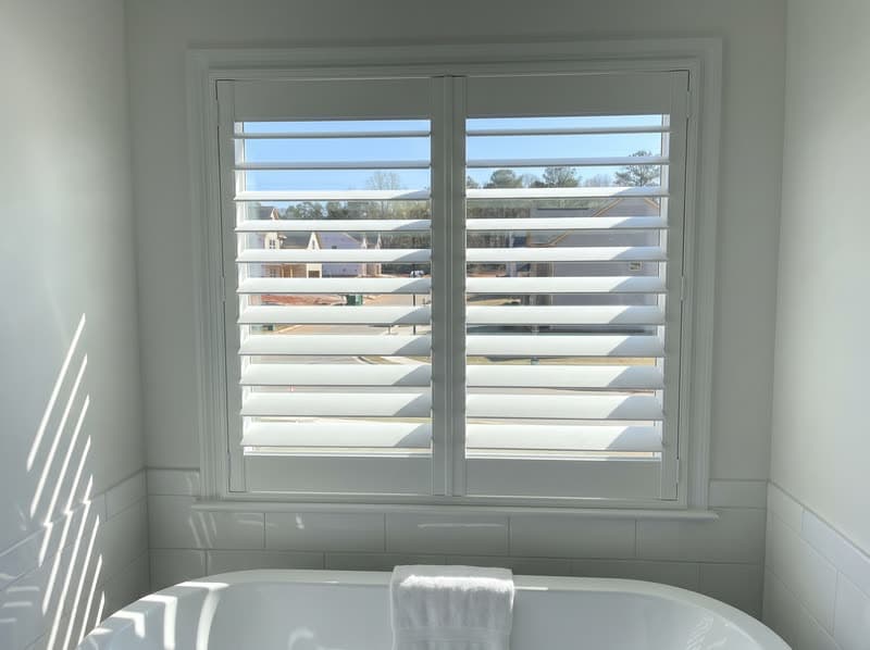 Composite shutters on a bathroom window in a new build in a modern subdivision in Johns Creek