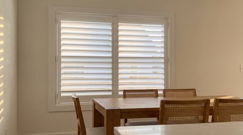 Composite shutters on a dining room window in a luxury modern villa in Duluth