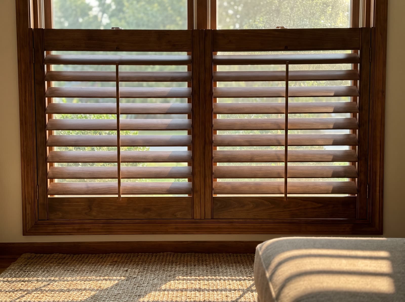 Wood shutters on a living room window in a 1990s brick colonial in Alpharetta