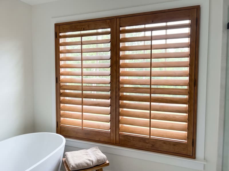 Wood shutters on a bathroom window in a new build in a modern subdivision in Johns Creek